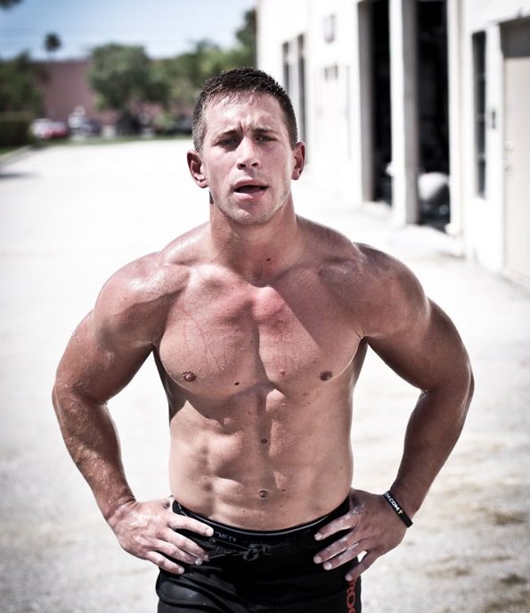 Dan Bailey standing shirtless outdoors in the sun, looking strong and lean