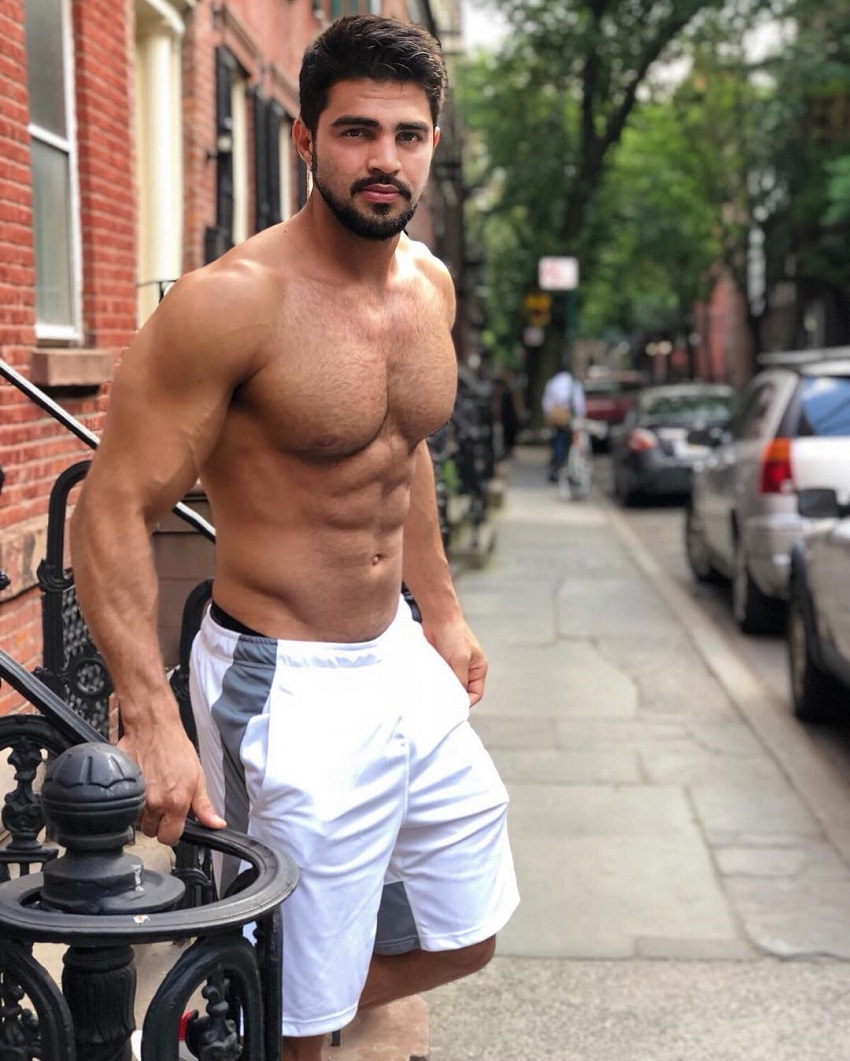 Jefferson Ferreira standing shirtless on the street looking ripped and muscular