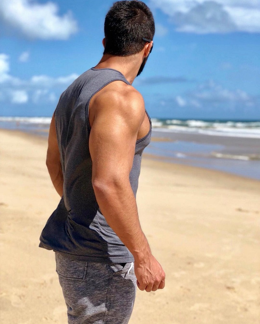 Jefferson Ferreira looking muscular and ripped in his tank top shirt on a beach