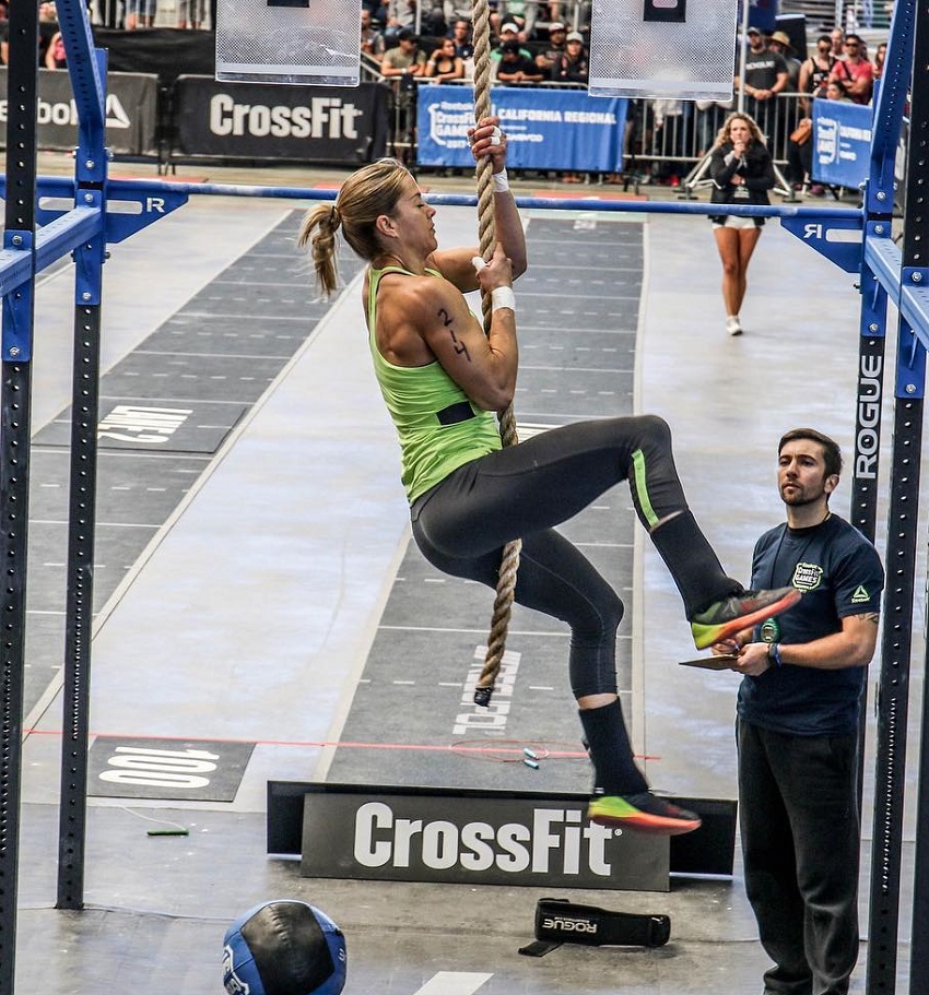 Rebecca Voigt Miller climbing rope during a CrossFit competition