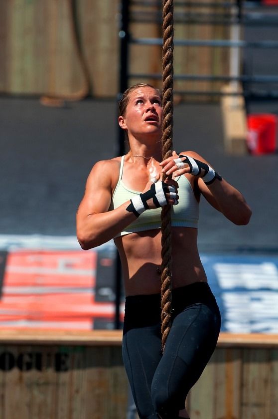 Rebecca Voigt Miller climbing rope during a CrossFit event