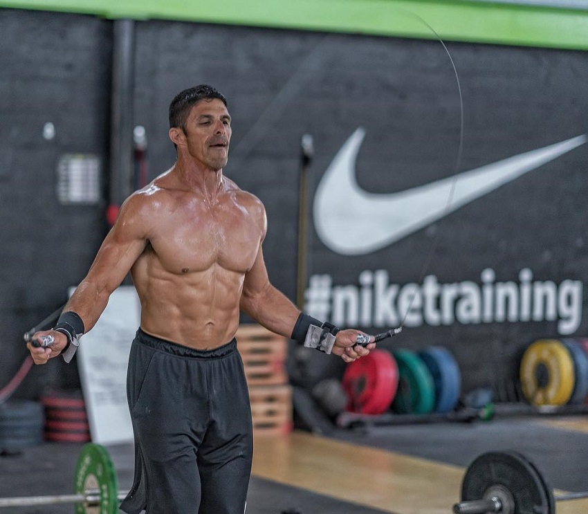 Shawn Ramirez skipping ropes shirtless during a CrossFit workout.