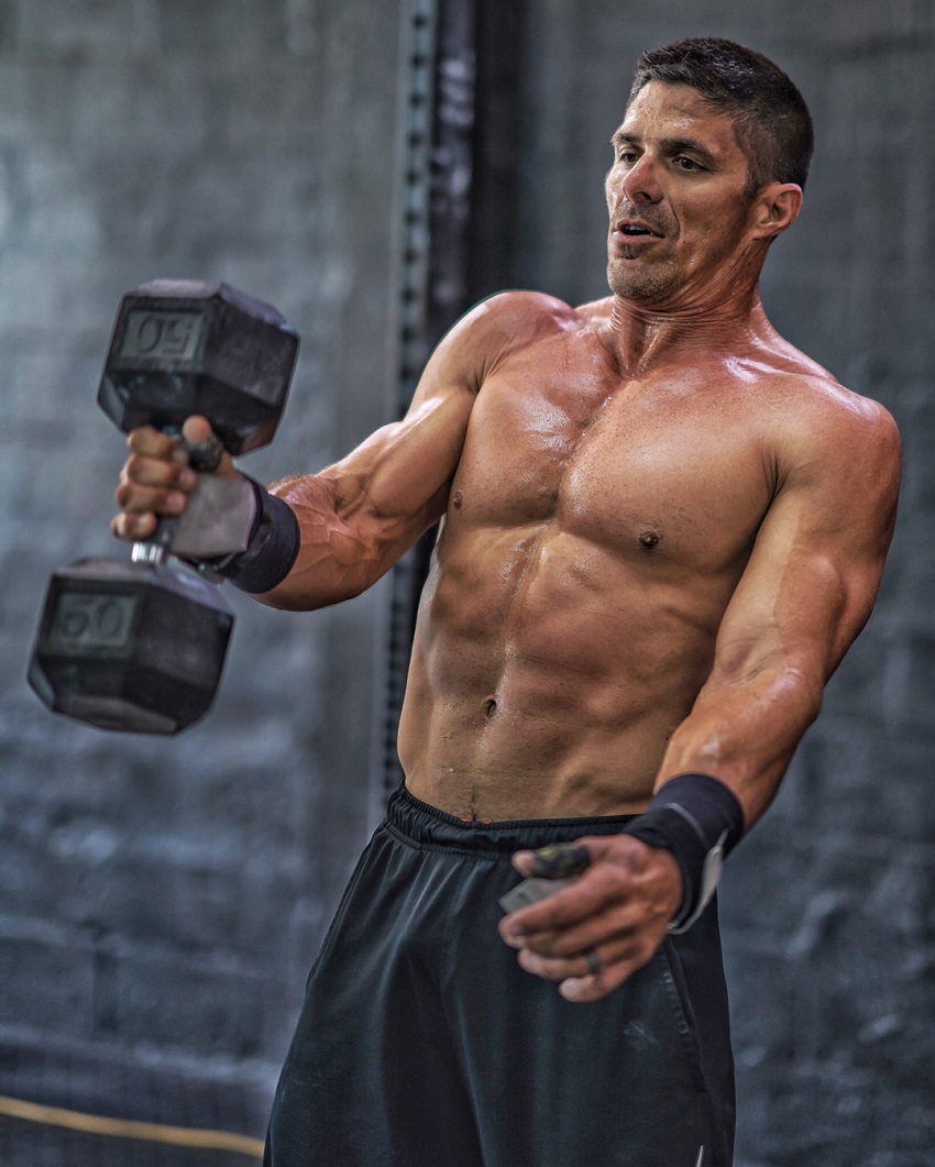 Shawn Ramirez lifting a dumbbell looking ripped and strong.