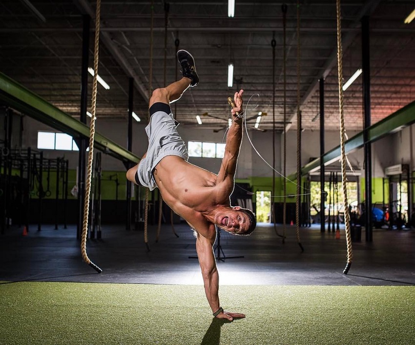 Shawn Ramirez doing a handstand while shirtless looking fit and strong