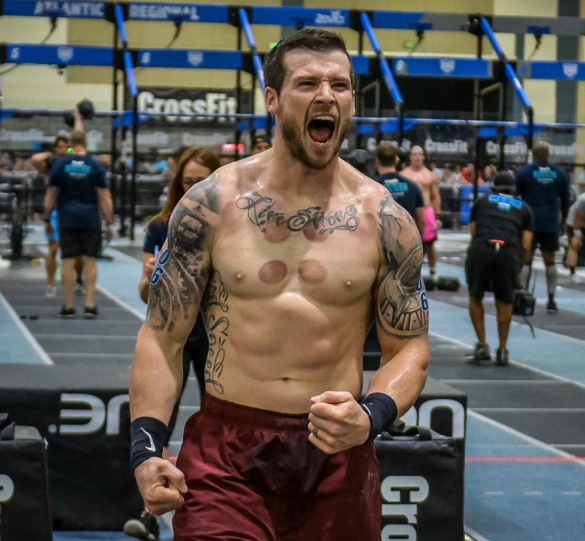 Travis Mayer with a roaring expression on his face during a CrossFit contest looking fit and strong