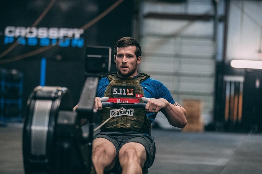 Travis Mayer performing cable pulls for lats in a CrossFit Gym