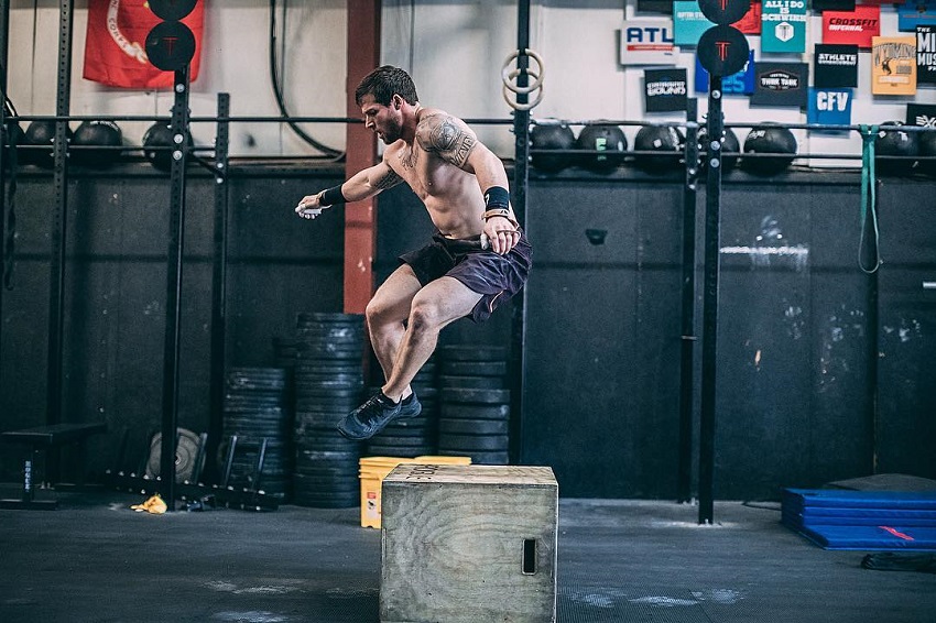 Travis Mayer working out in a CrossFit gym