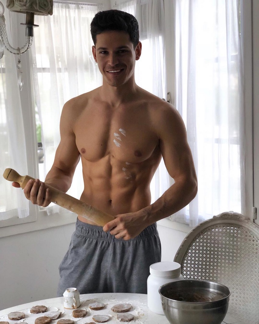 Andrea Moscon posing shirtless in the kitchen