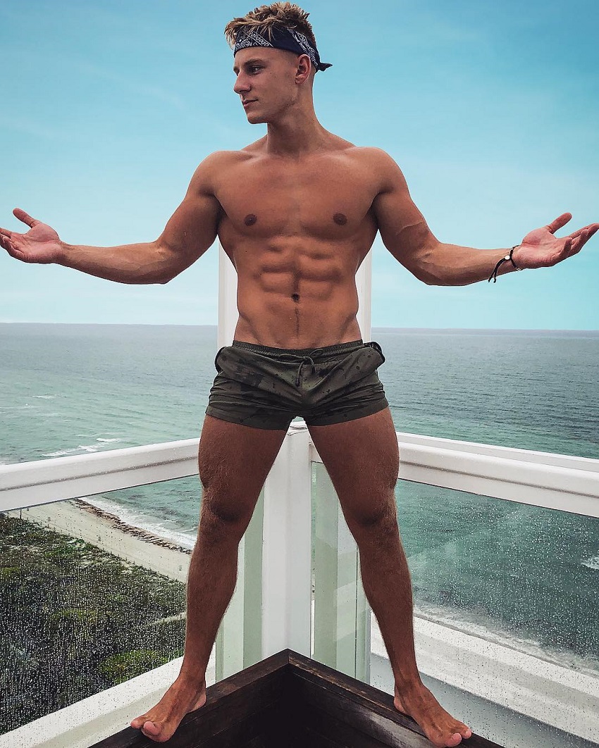 Max Wyatt posing on a balcony looking fit and lean