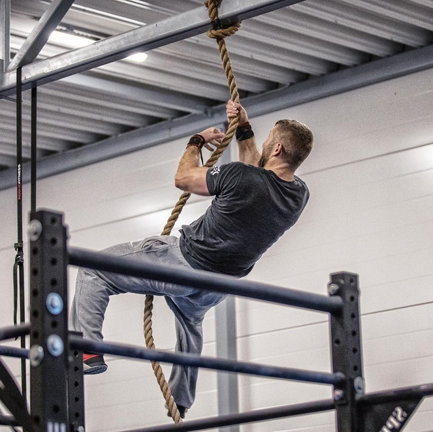 Mikko Salo climbing a rope looking fit and strong