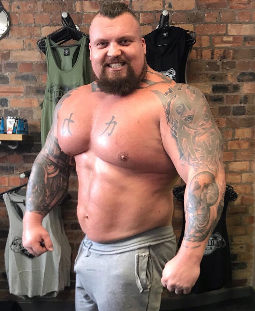 Eddie Hall posing shirtless for the photo looking strong and big