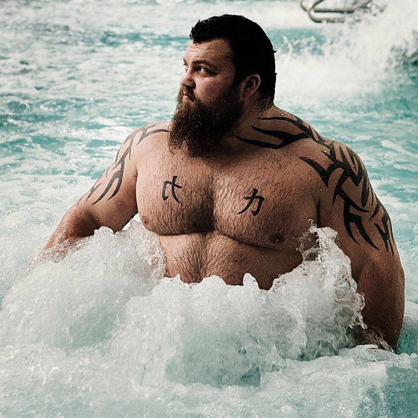 Eddie Hall standing in the pool looking big and muscular