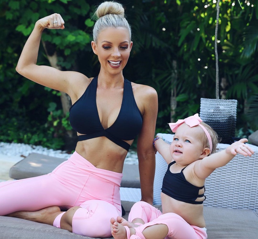Hannah Polites flexing with her baby girl
