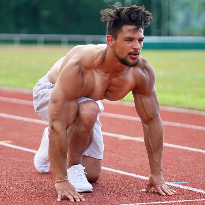 Jamar Pusch preparing to run on a track looking big and ripped