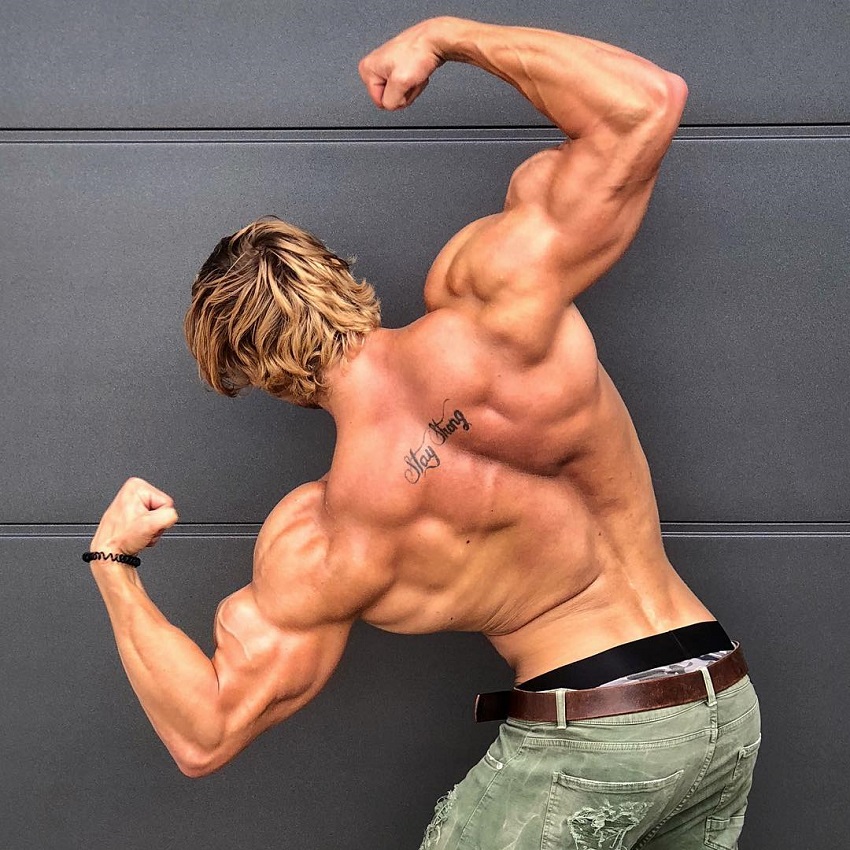 Jo Linder doing a back double biceps pose looking strong and aesthetic