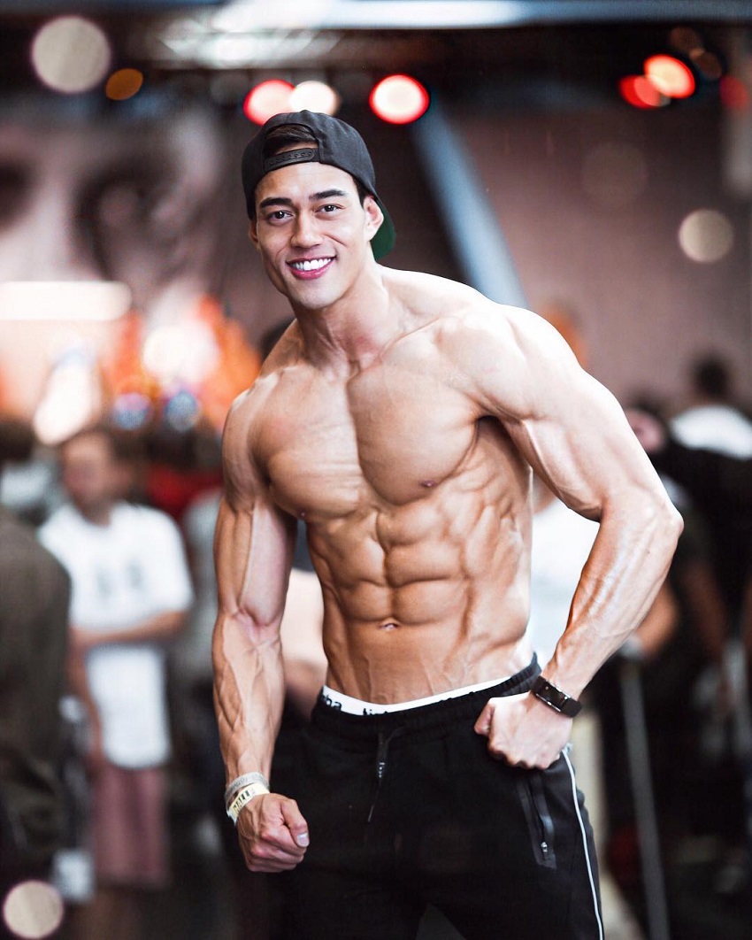 Nam Vo flexing shirtless for the photo looking ripped