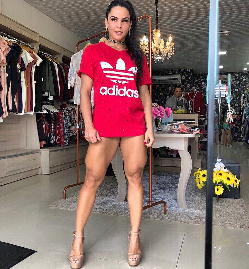 Karolina Marreiro posing for a photo in a red t-shirt showing off her muscular and feminine legs