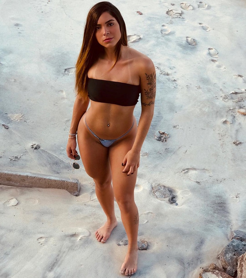 Luana Targino posing on a beach looking fit and lean