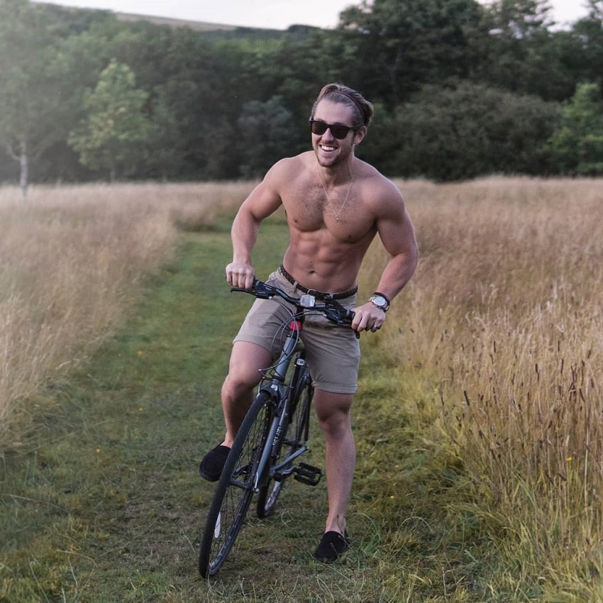 Matt Lucas looking ripped on his bike in nature