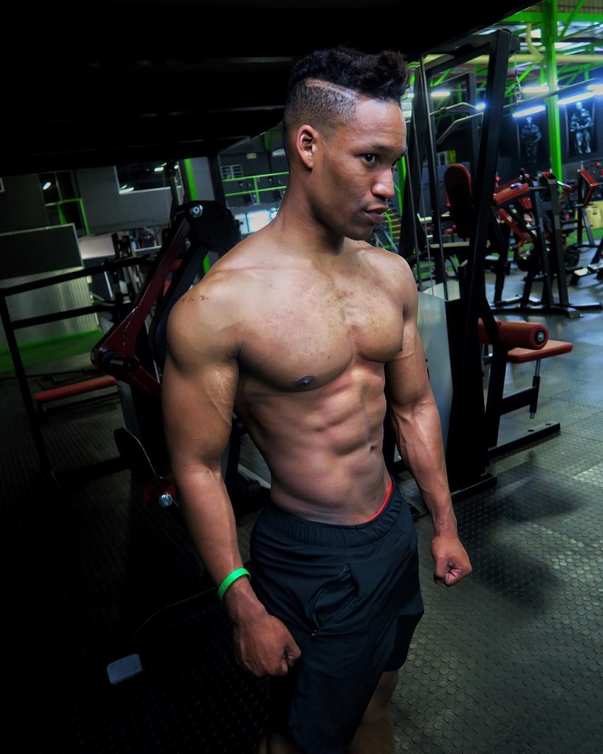 Mike Diamonds posing shirtless in a gym looking fit and lean