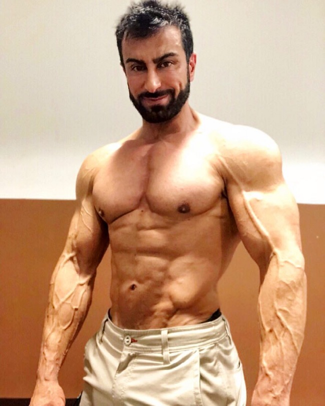 Murat Demir posing shirtless for the photo looking lean and strong
