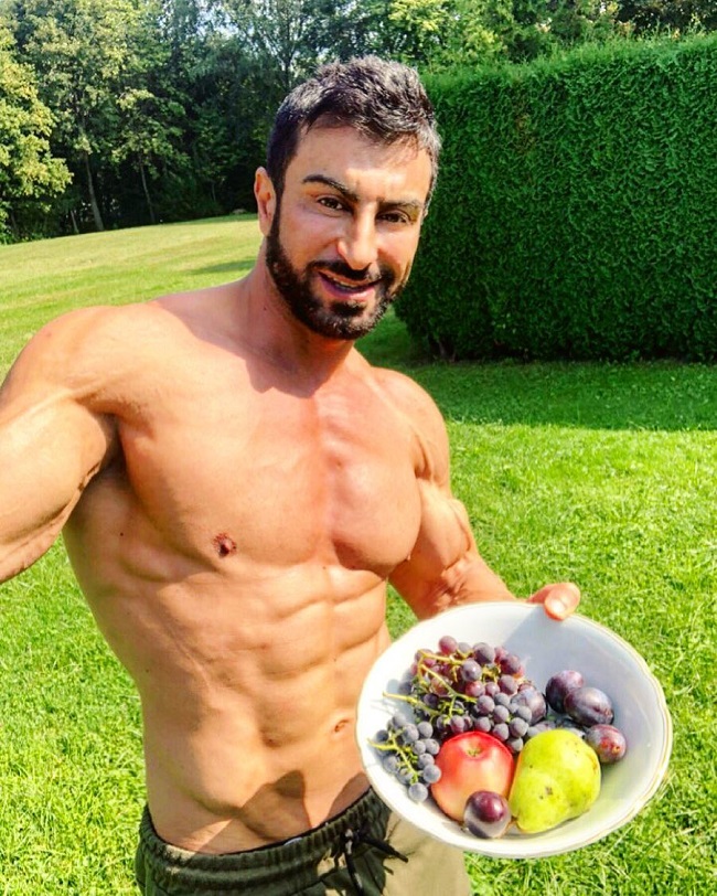 Murat Demir posing shirtless with a bowl of fruit