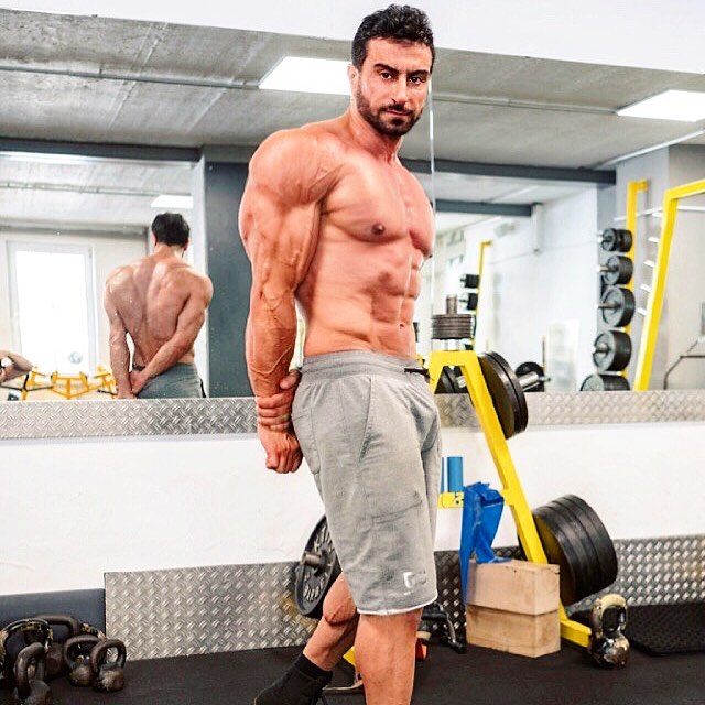 Murat Demir flexing his triceps for the camera