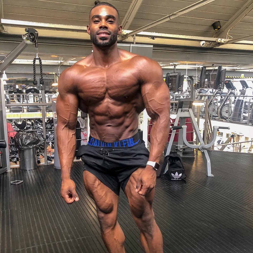 Nathan Williams posing shirtless for the photo looking lean and strong