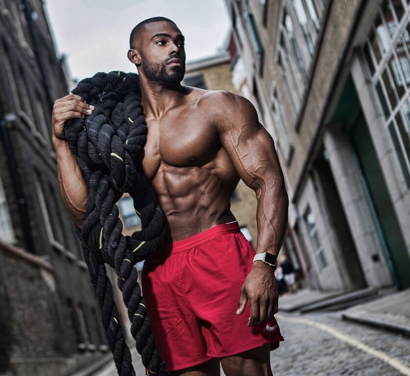 Nathan Williams posing shirtless with ropes during a photo shoot