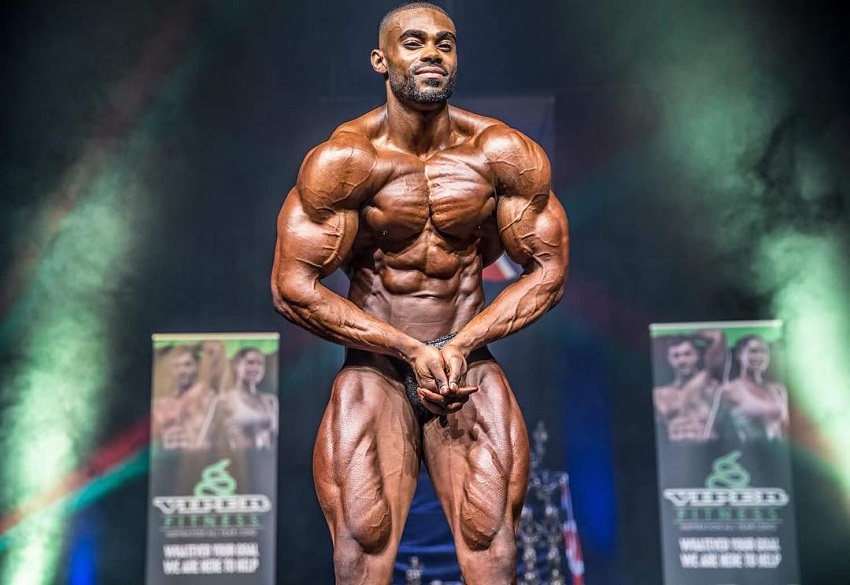 Nathan Williams doing the most muscular pose on the stage looking big and ripped