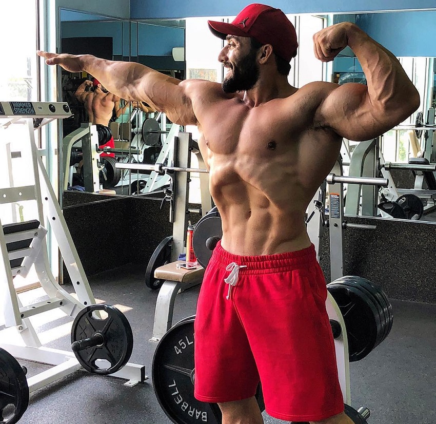 Abtin Shekarabi flexing in the gym looking strong and lean