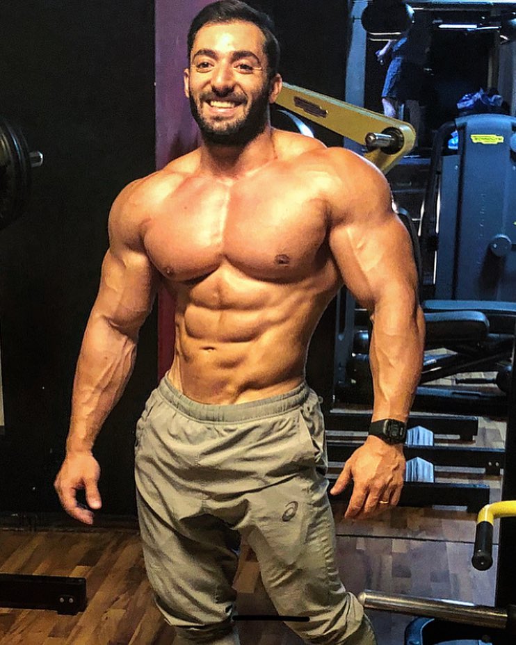 Abtin Shekarabi posing for a picture looking muscular and ripped