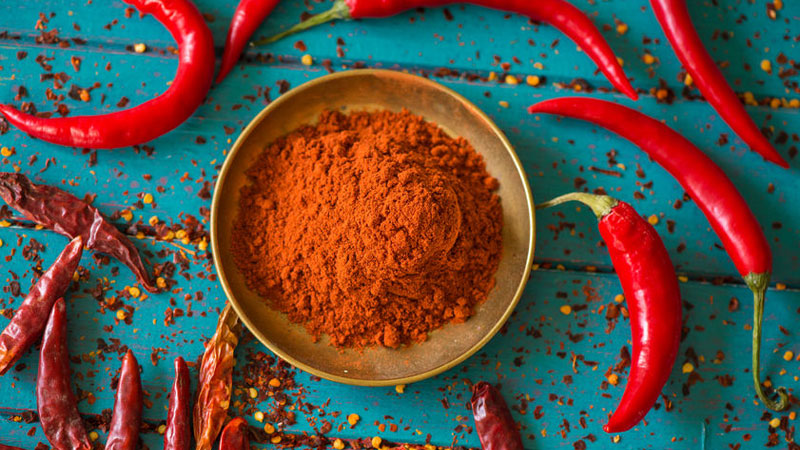 Chili pepper powder on a blue table