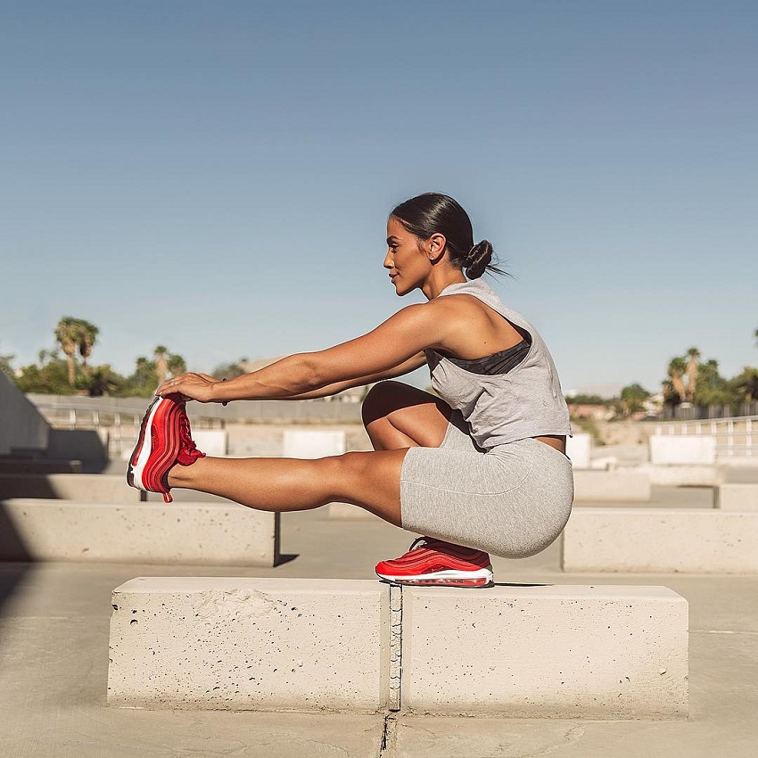 Giuliana Ava performing an exercise on a building rooftop