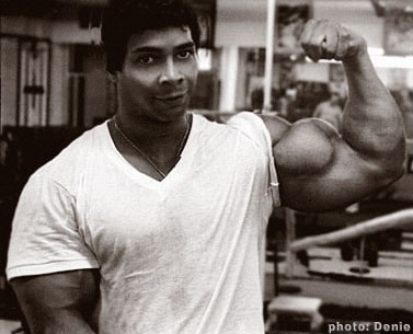 Harold Poole flexing his biceps for a photo looking strong and ripped