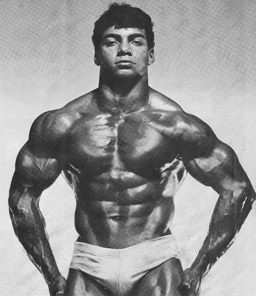 Harold Poole performing a bodybuilding pose looking big and ripped