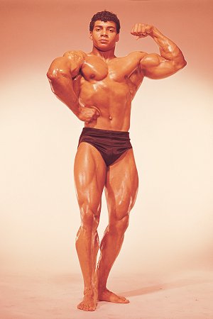 Harold Poole flexing his muscles in a bodybuilding photo shoot