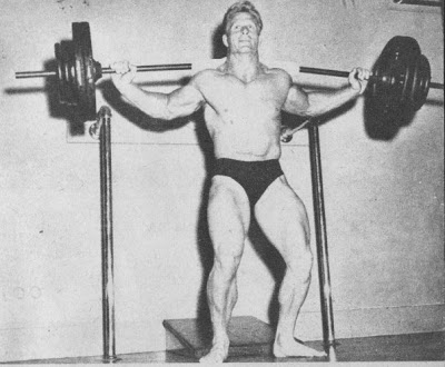 Jack Delinger training with a heavy barbell on his back in bodybuilding