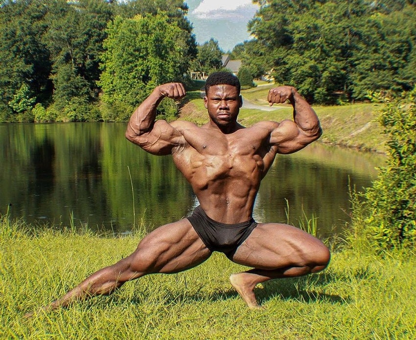 Keone Pearson posing shirtless by a lake looking ripped and aesthetic