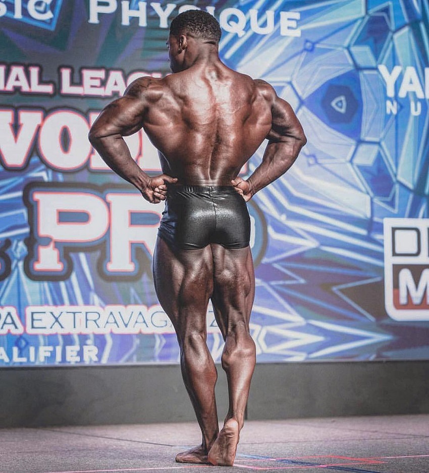 Keone Pearson performing a rear lat spread on the bodybuilding stage