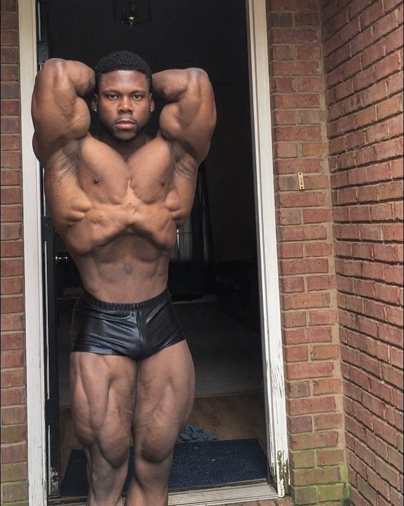 Keone Pearson flexing his bulging and ripped muscles for the camera