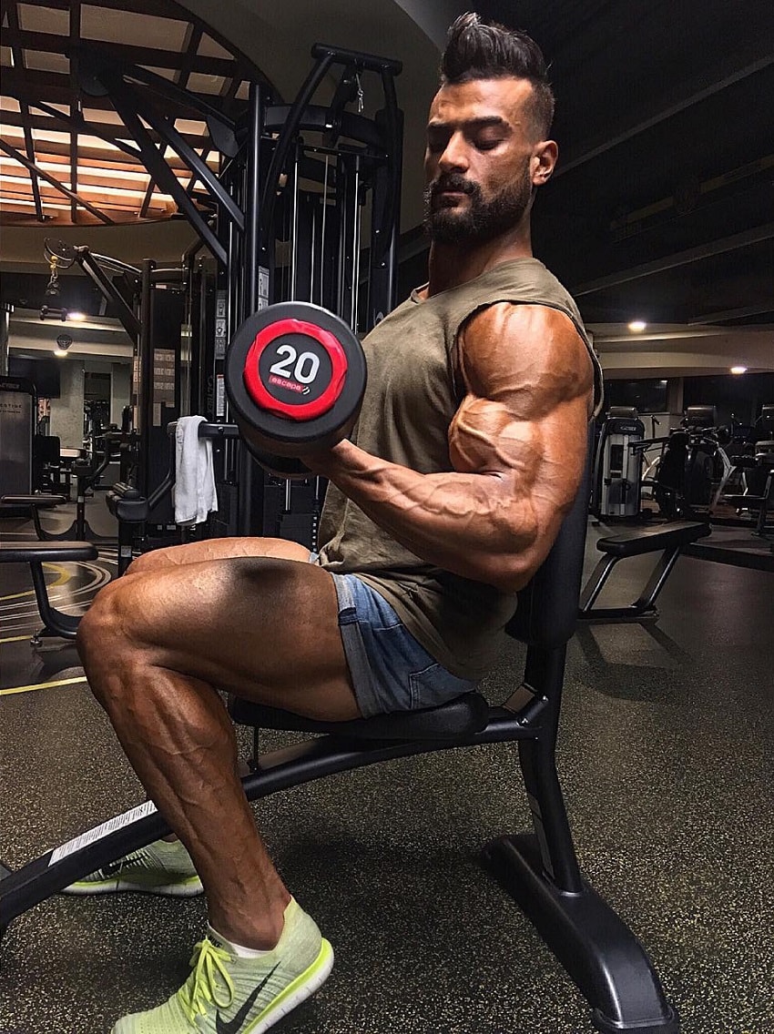 Mohamed El Qadi training arms in a gym