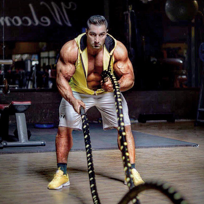 Rouhollah Mirhoseini performing a battle ropes exercise looking ripped and swole