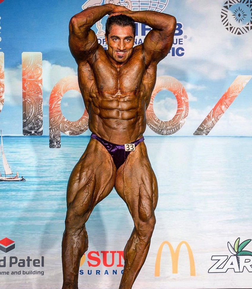 Rouhollah Mirhoseini showcasing his bulging abs in a bodybuilding contest