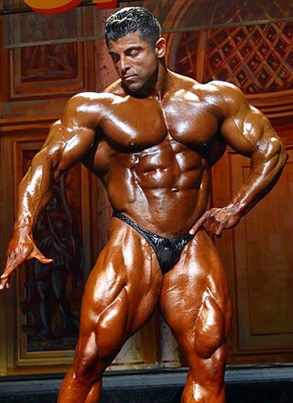 Shahriar Kamali showing off his immaculate physique in a bodybuilding contest