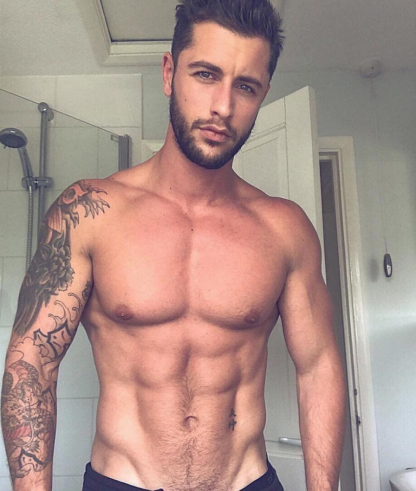 Vince Azzopardi posing shirtless in a bathroom