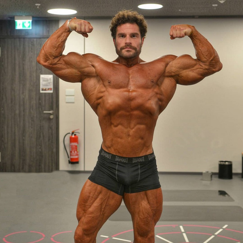 David Hoffmann performing a front double biceps pose for the camera