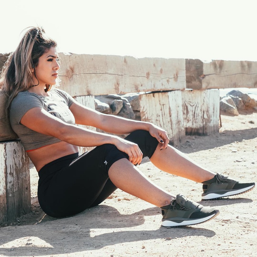 Heba Ali sitting on sand looking fit