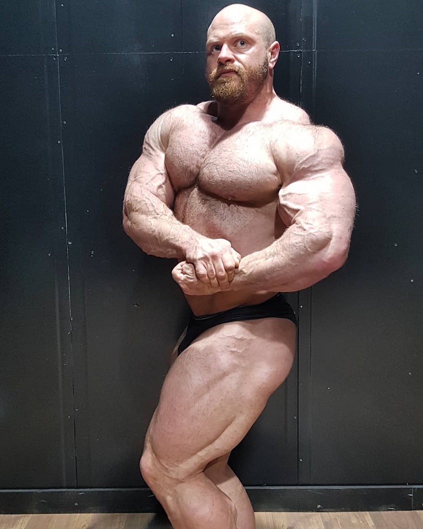 James Hollingshead performing a shirtless side chest pose