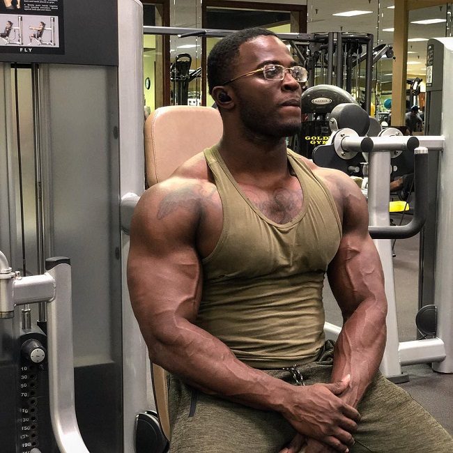 Kenneth Owens sitting by a peck deck machine in a gym